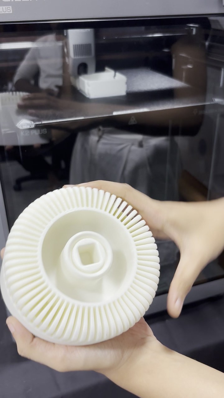 Large 3D printed centrifugal impeller held in two hands in the Cerox print lab