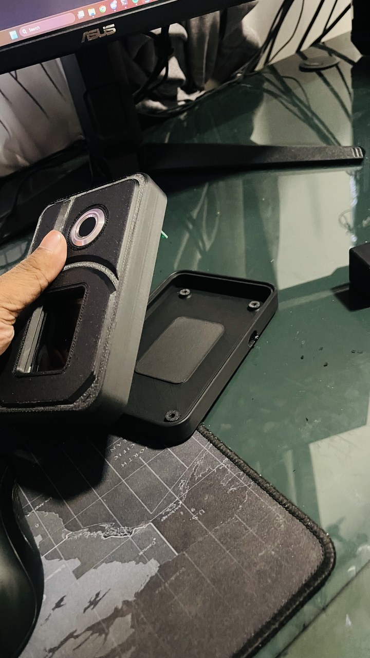 Custom printed black sensor enclosure with lens aperture, opened to show the internal cavity